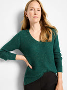 Shimmering emerald green waffle V-neck sweater.