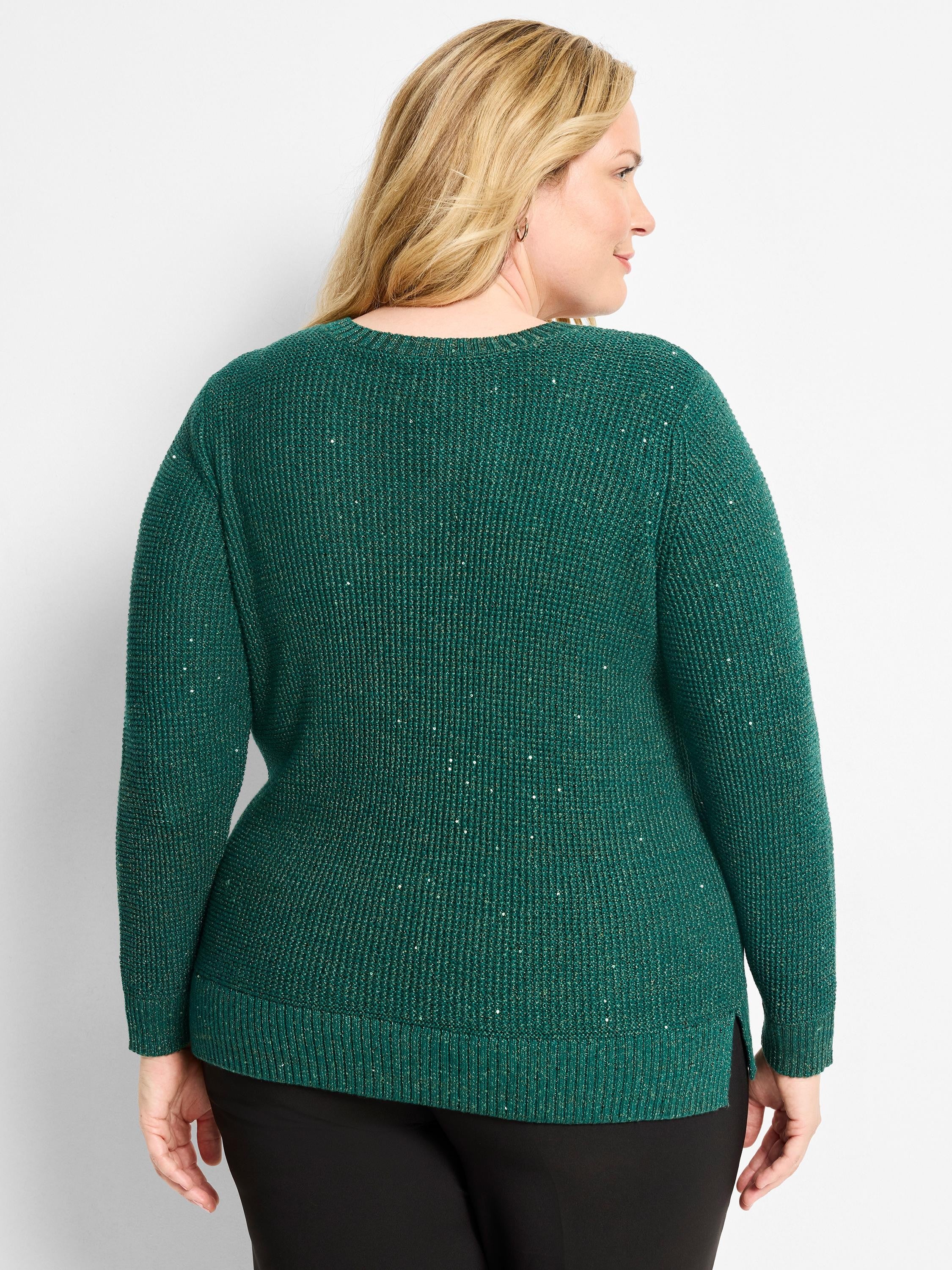 Dark green waffle knit sweater with shimmering threads. Features a relaxed fit and ribbed cuffs/hem.