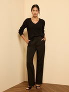 Black waffle knit V-neck sweater with subtle shimmer details.