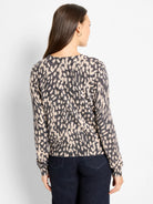Black and cream wild dot pattern pullover sweater, back view.