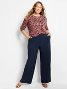 Ikat cotton sweater with dark base, red-orange & blue blurred diamond pattern. Crew neck, 3/4 sleeves.