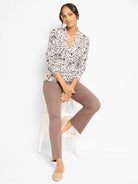 Cream V-neck sweater with a cheetah print in black, tan, and blue spots.