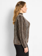 Ombre pixel knit sweater in black and beige, with a textured pattern of small squares and a mock neck collar.