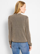 Black and tan pixel-knit cardigan with long sleeves and high neck, viewed from the back on a model.