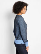 Black & light blue pixel knit funnel neck sweater with solid light blue ribbed cuffs and hem.
