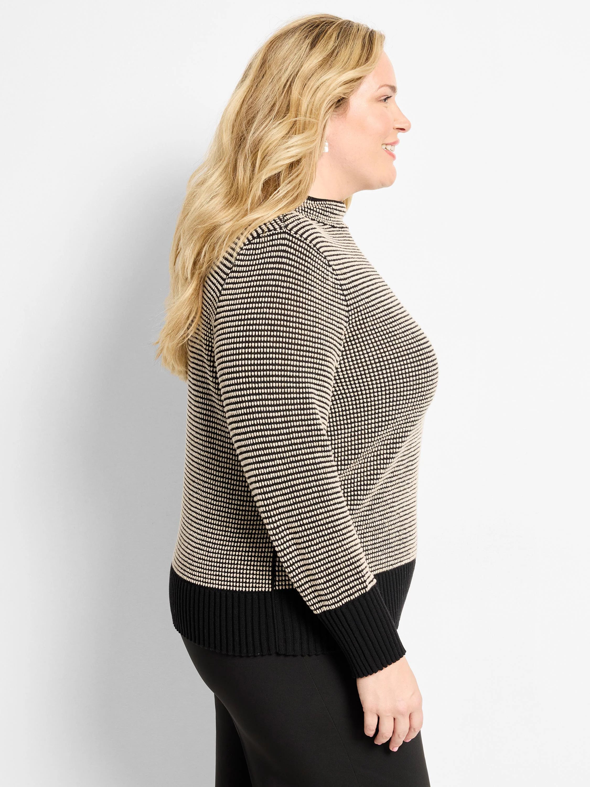 Funnel neck pixel knit sweater in black & beige. Textured pattern, with solid black ribbed cuffs & hem.