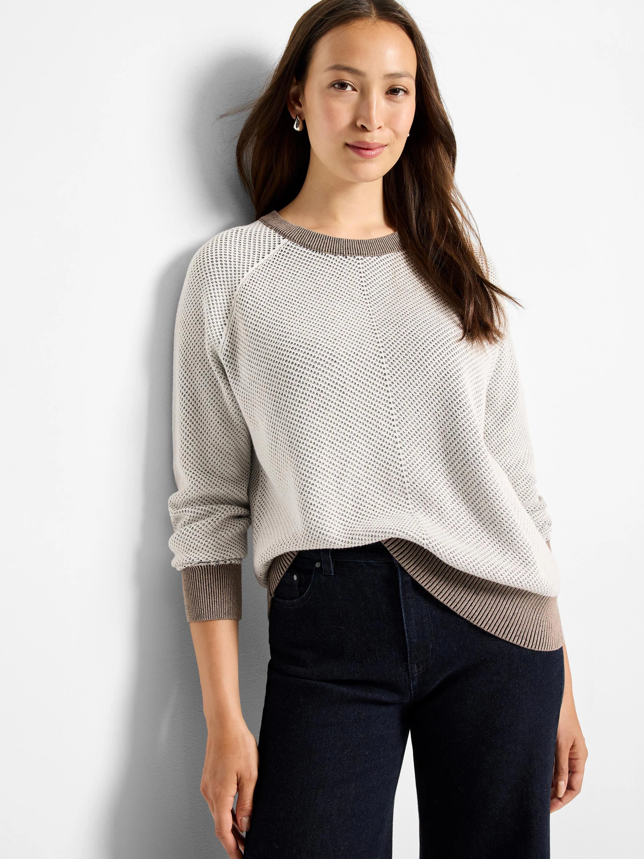 Light beige open knit sweater with brown ribbed collar, cuffs, and hem.