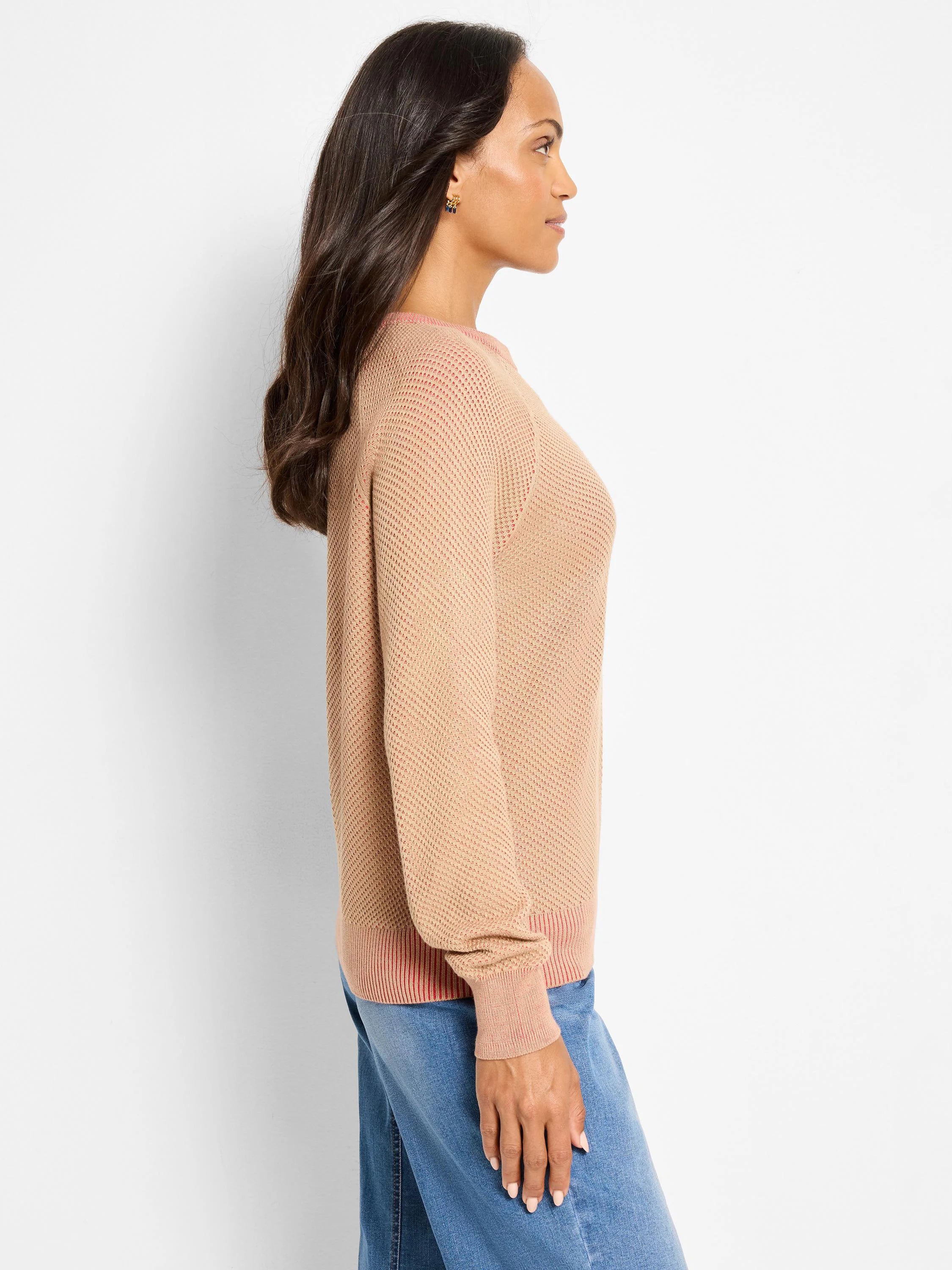 Beige open knit sweater with pink accents at neckline, cuffs, and hem.