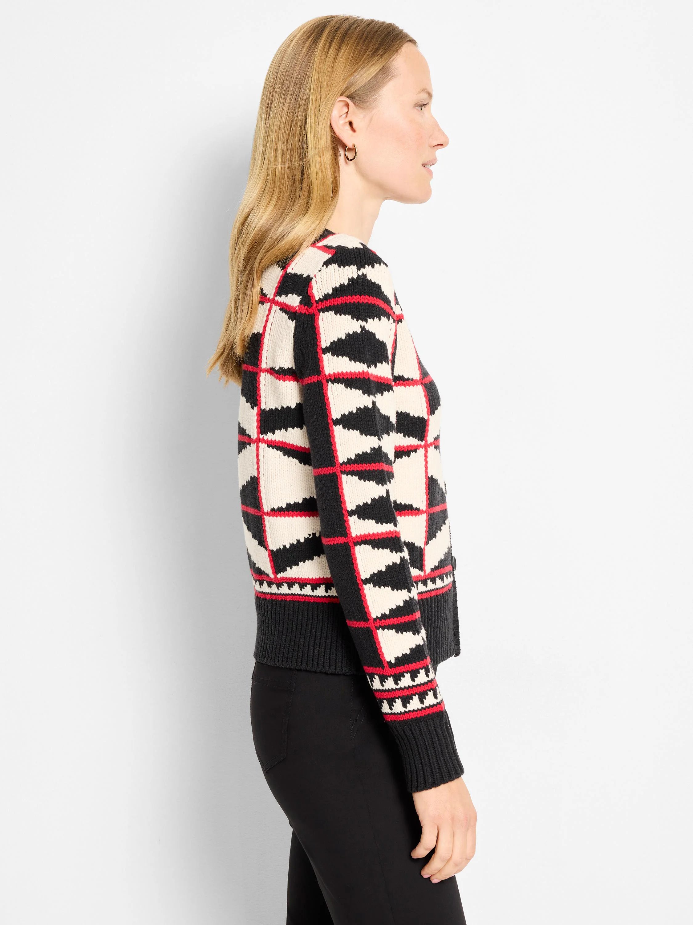 Cream cardigan with black zig-zag shapes and red lines forming a grid pattern. Ribbed cuffs and hem.