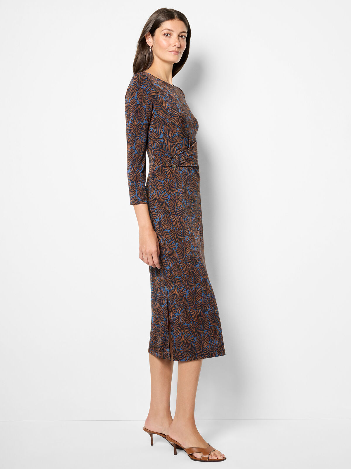 Woman wearing a patterned dress on a white background