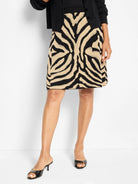 Black and beige zebra print jacquard knit skirt, A-line shape, above the knee.