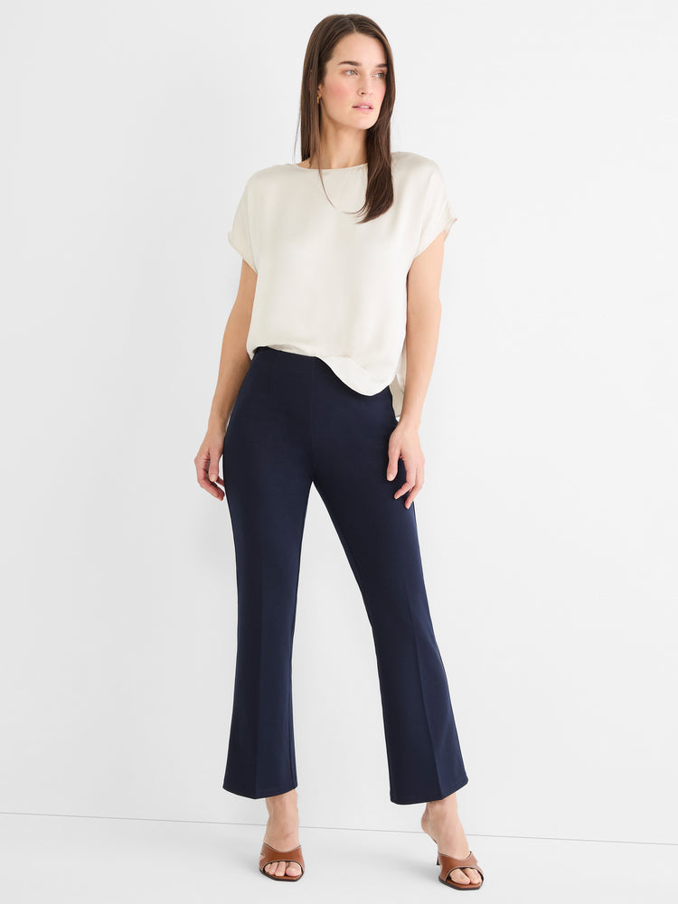 Dark blue high-waisted cropped pants feature a slim fit through the thigh and a subtle flare at the ankle.