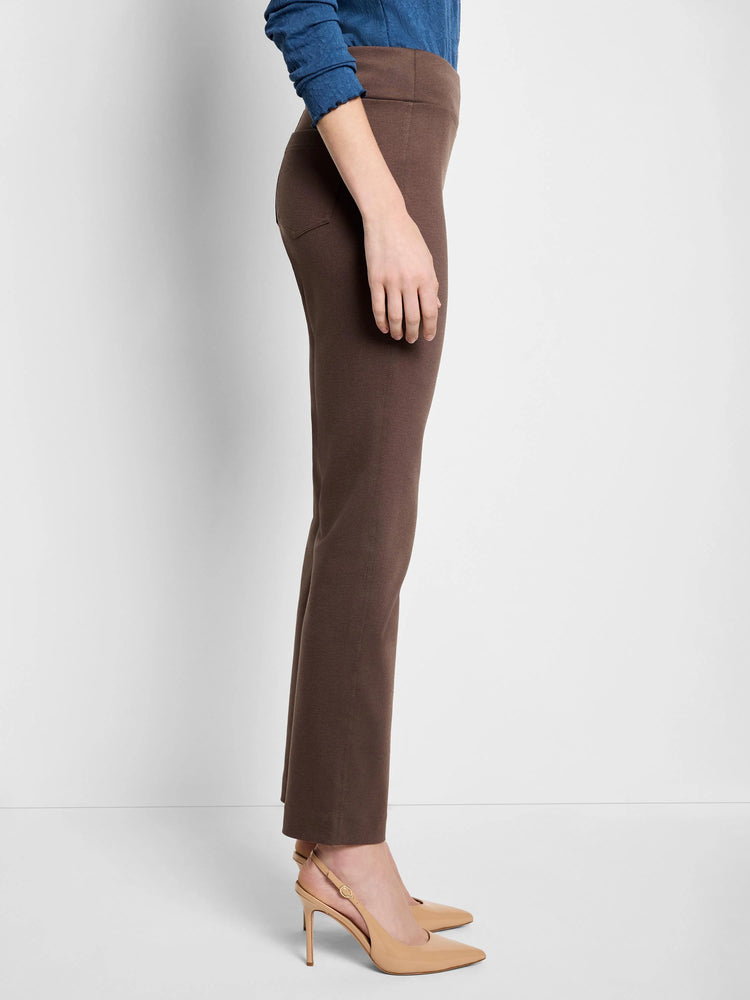 Side view of dark brown straight-leg pants on a model. The pants are mid-rise with a subtle sheen.