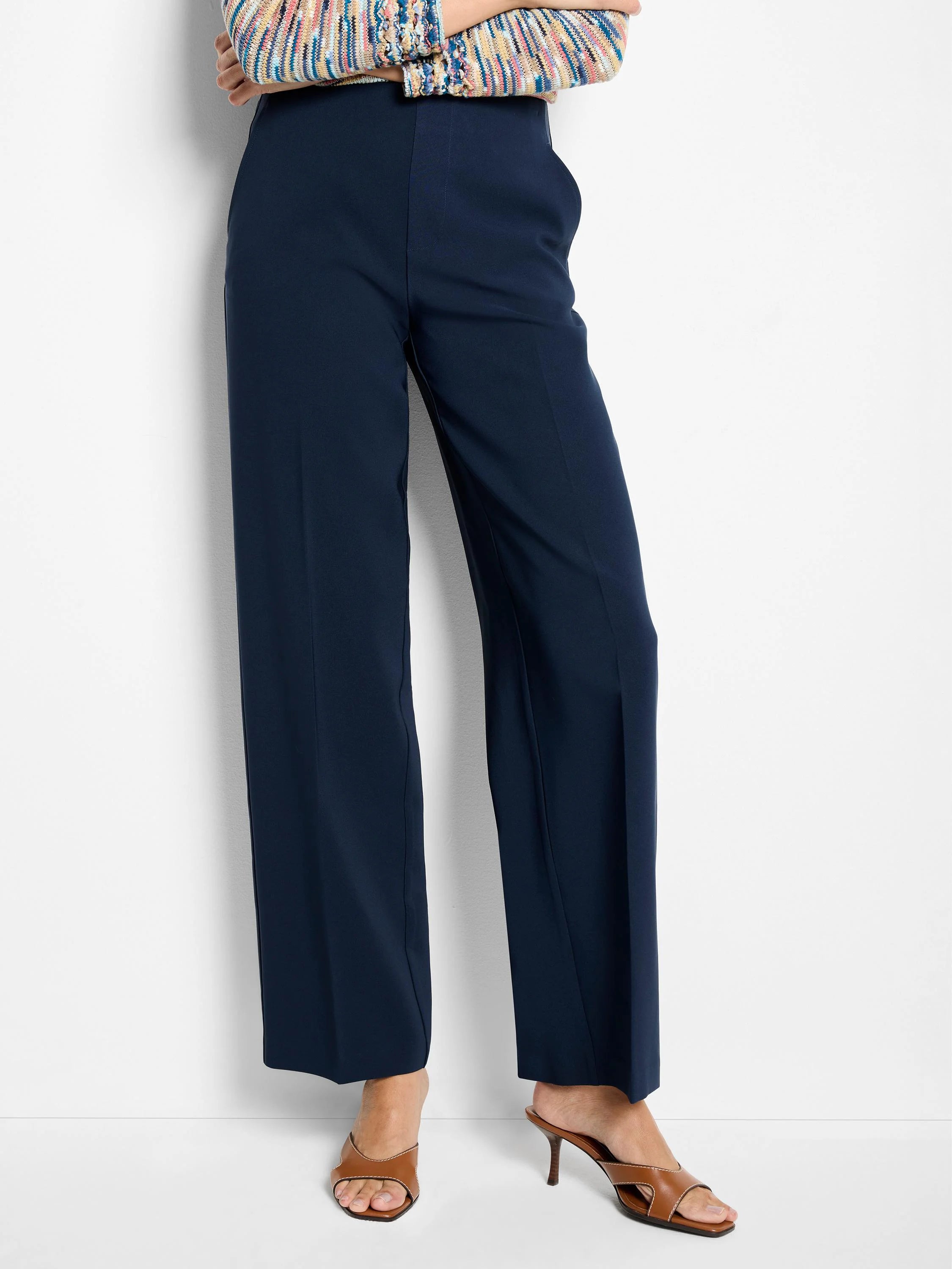 Navy wide-leg pants with a sleek fabric, featuring a flat front and pressed leg creases.