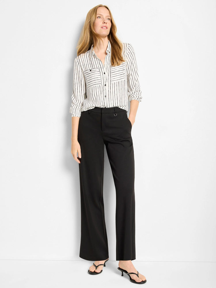 Black wide-leg pants with a small silver buckle detail at the waist. A model is wearing them with a striped shirt.