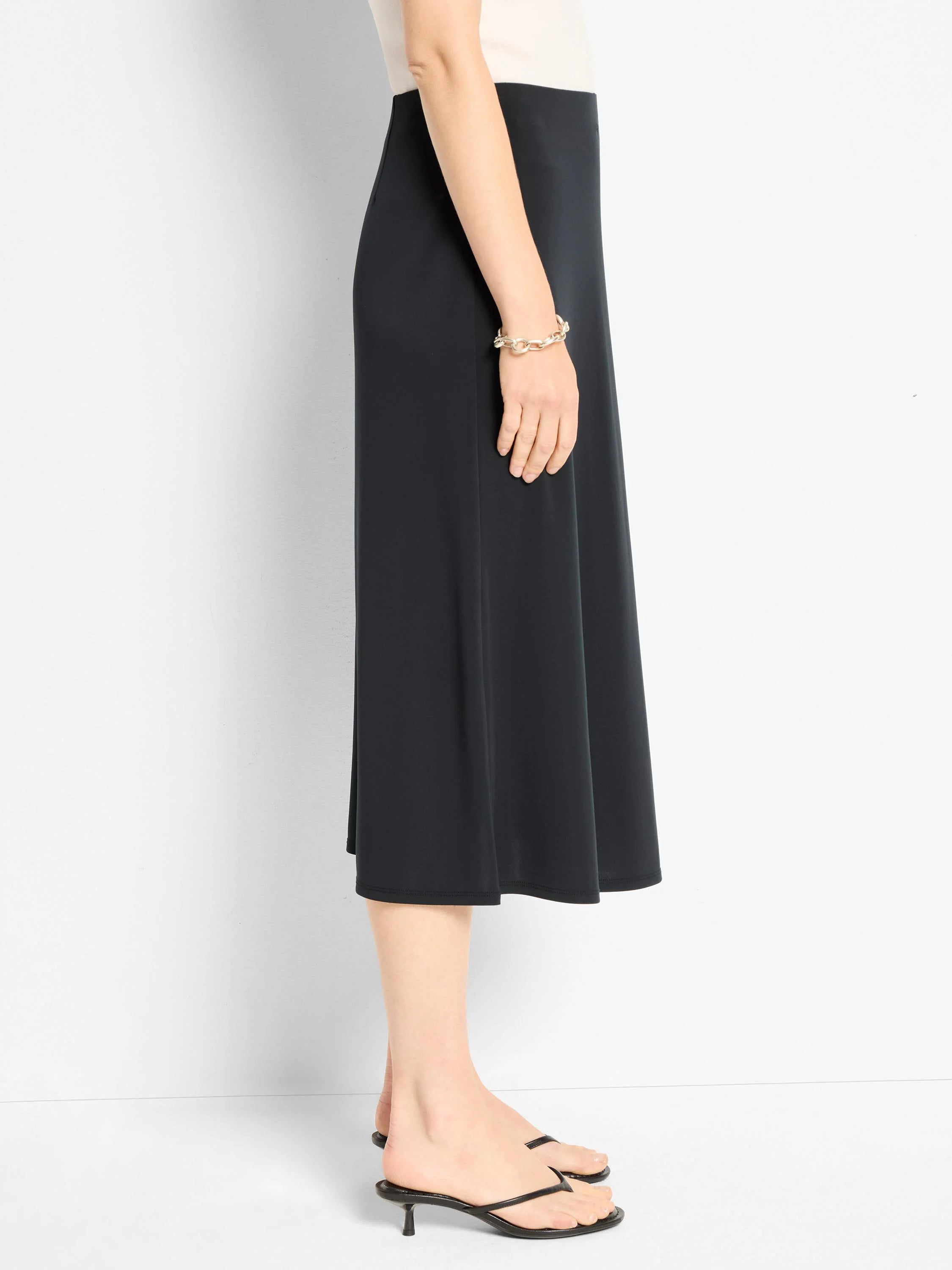 Black A-line midi skirt.  Simple, solid color.  Straight hem.