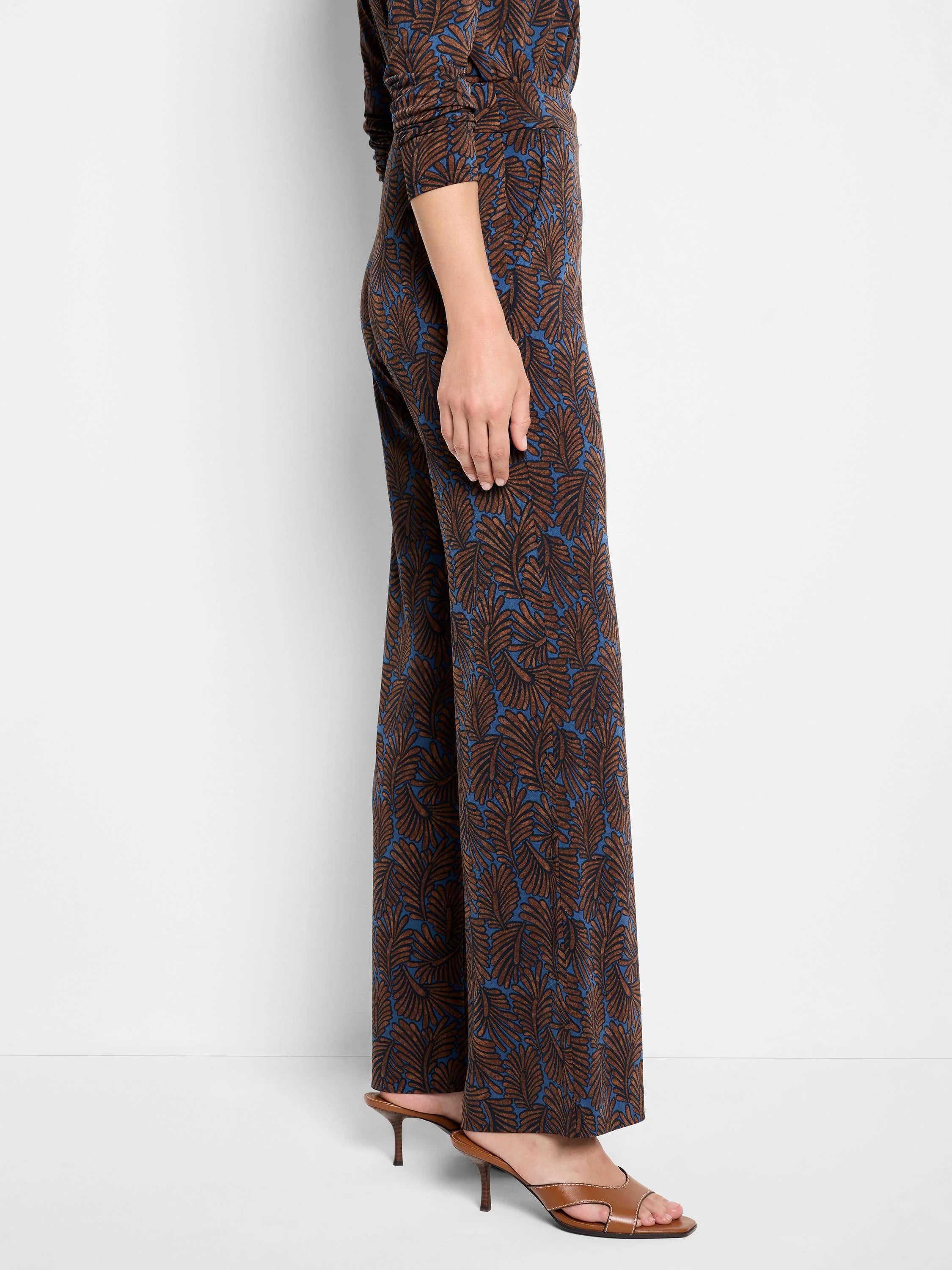 Wide-leg pants; brown & blue feather print.  Side view.
