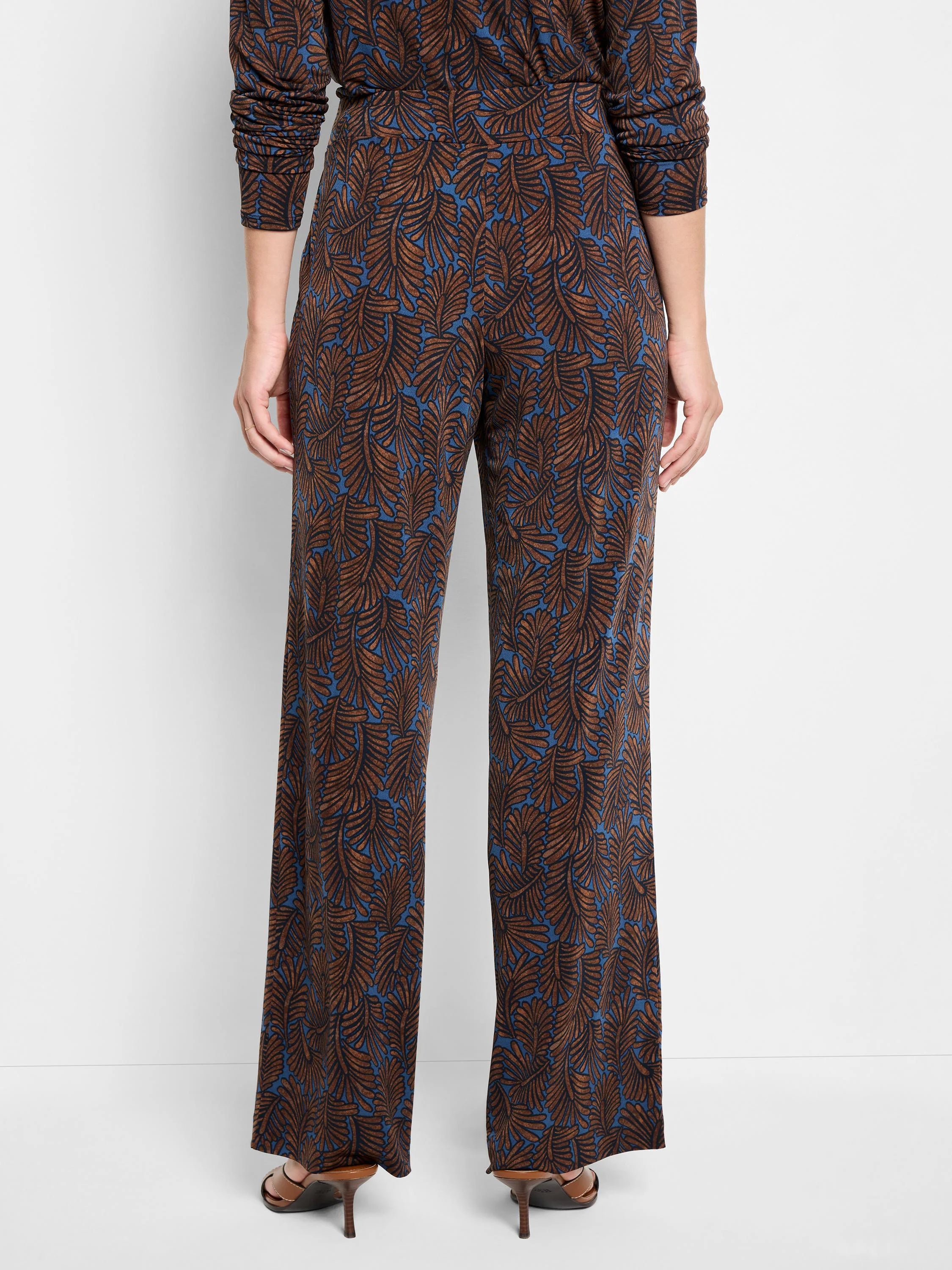Wide-leg pants; blue background with brown feather-like pattern.