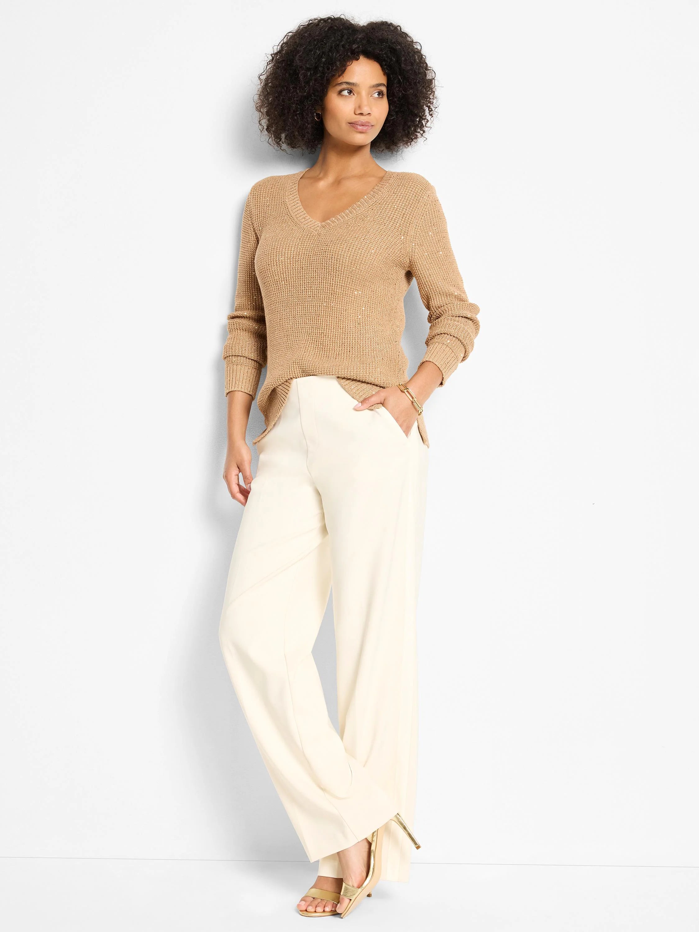 Cream, wide-leg, full-length pants with a sleek finish.