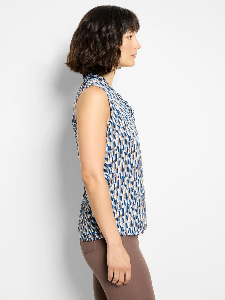 Sleeveless top, blue, beige, and white brushstroke pattern. Ruffled neckline.