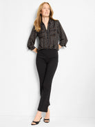 Black shirt with thin, irregular white and tan vertical stripes, button-down front, collared, and rolled sleeves.