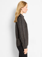 Black collared shirt with long sleeves & vertical painted stripes in white, cream, & brown.