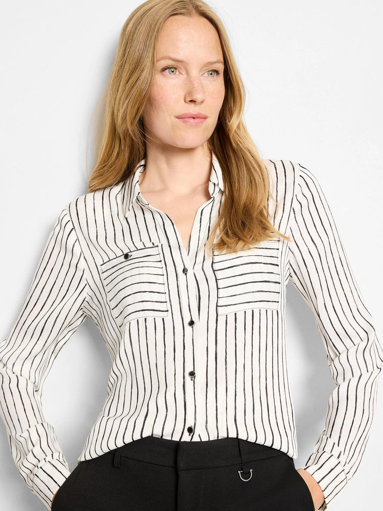 Cream button-up shirt with black irregular vertical painted stripes, a collar, and two chest pockets.