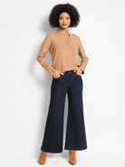 Tan long-sleeved V-neck top with a pattern of small white shadow dots.