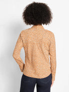 Tan long-sleeve top with a repeating pattern of white shadow dots, shown from the back.