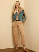 Dark green long-sleeve top with irregular white dot pattern.