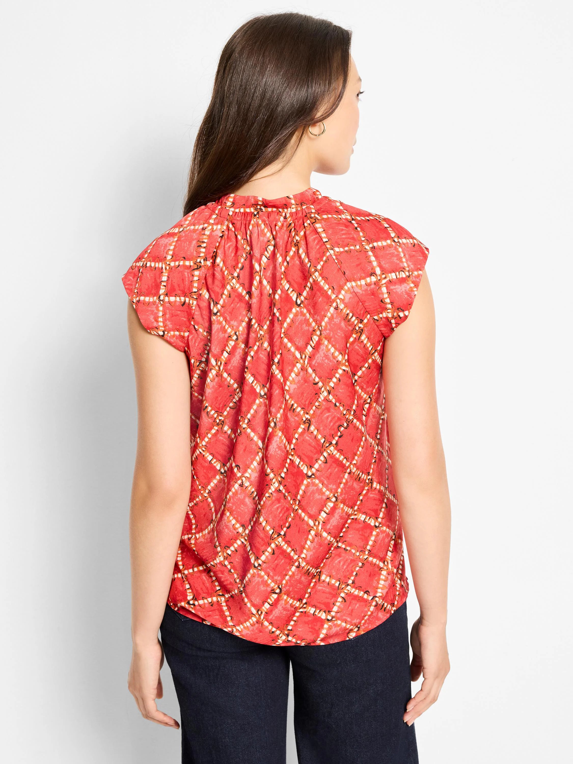 Reddish-orange cap sleeve top with white check & dark squiggle pattern, gathered back.
