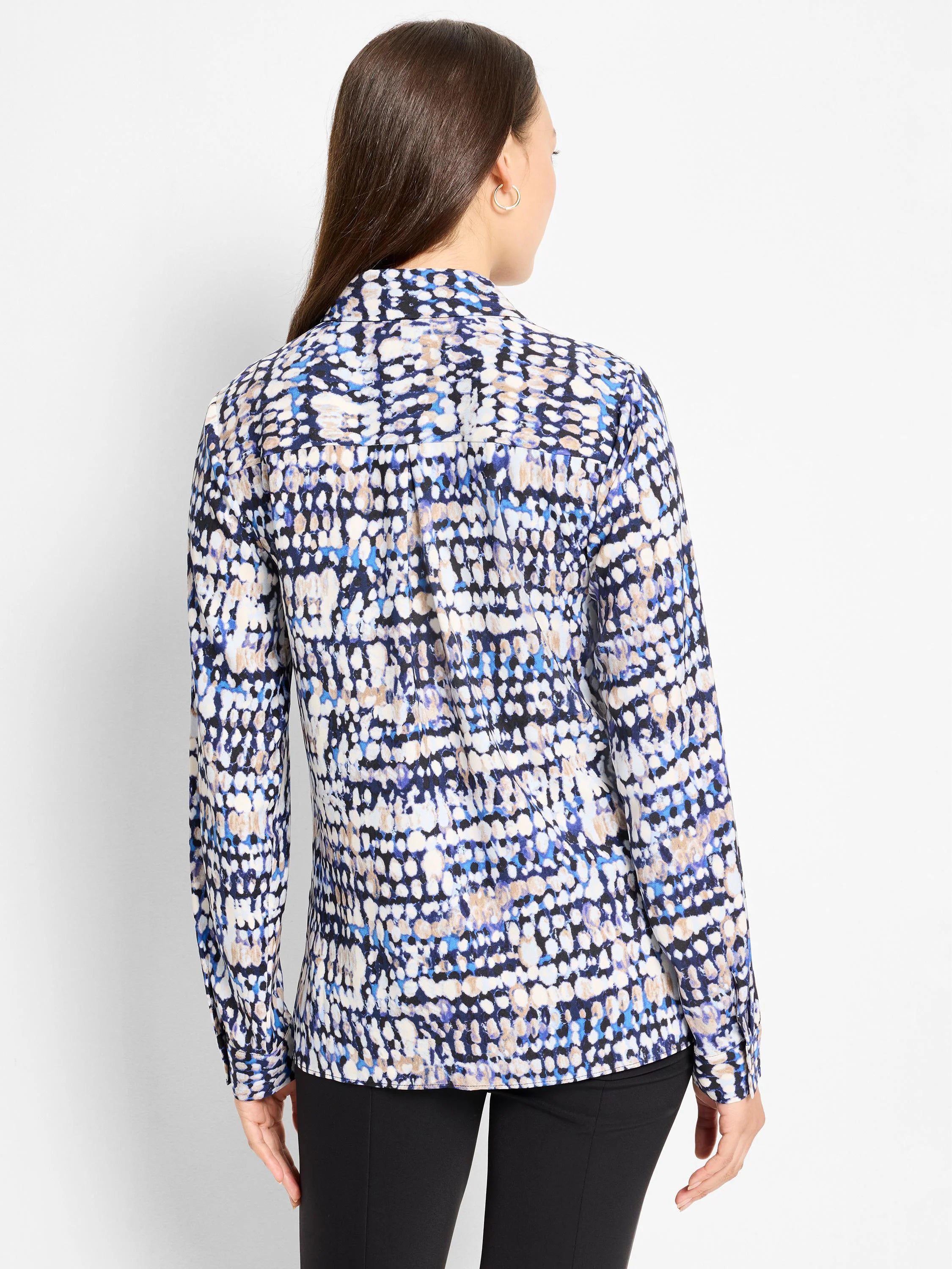 Long-sleeved top with an abstract dot pattern in navy, light blue, cream, and tan.