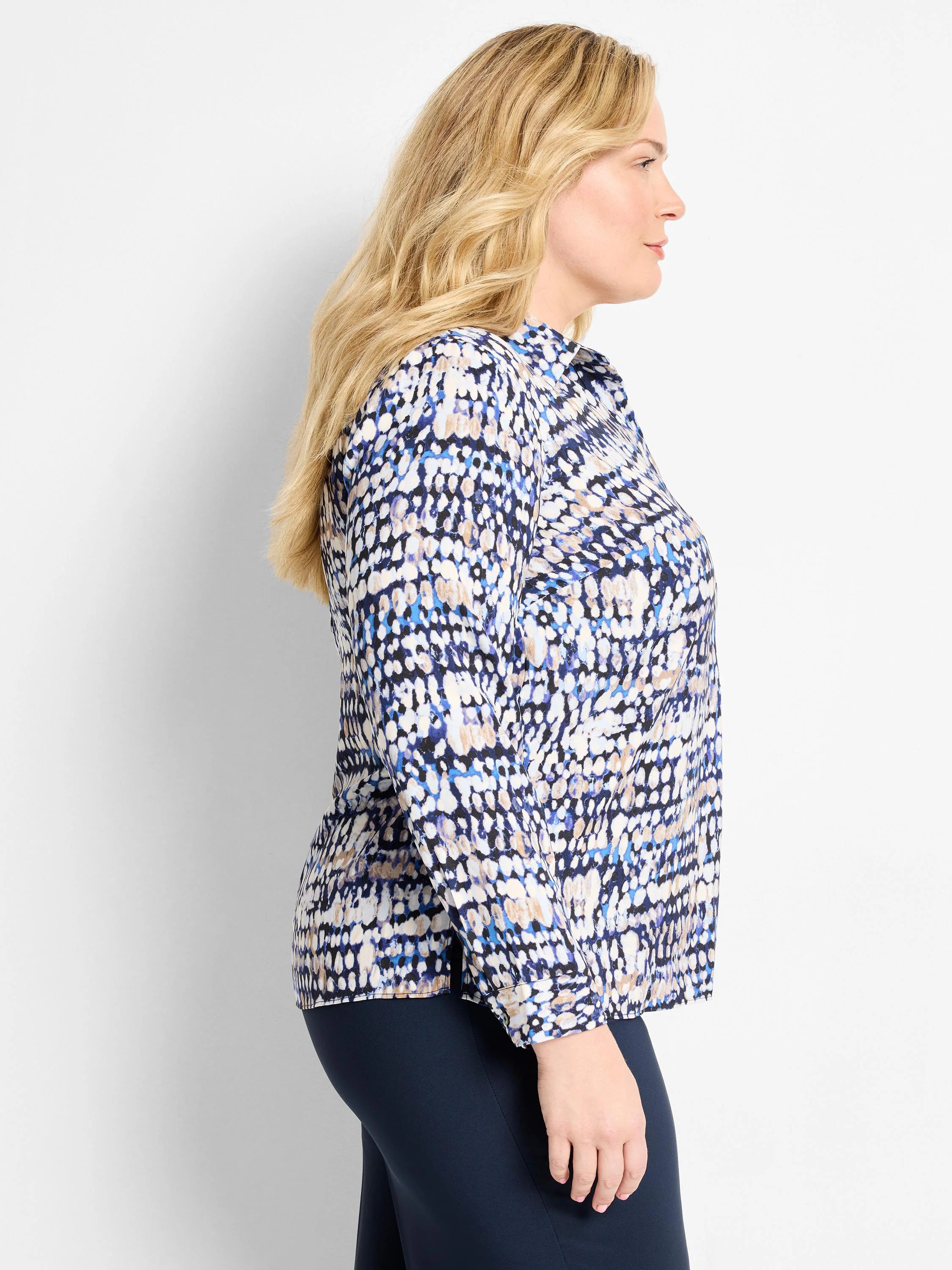 Long-sleeve top with an abstract dot pattern in shades of blue, cream, and tan. Features a collared design.