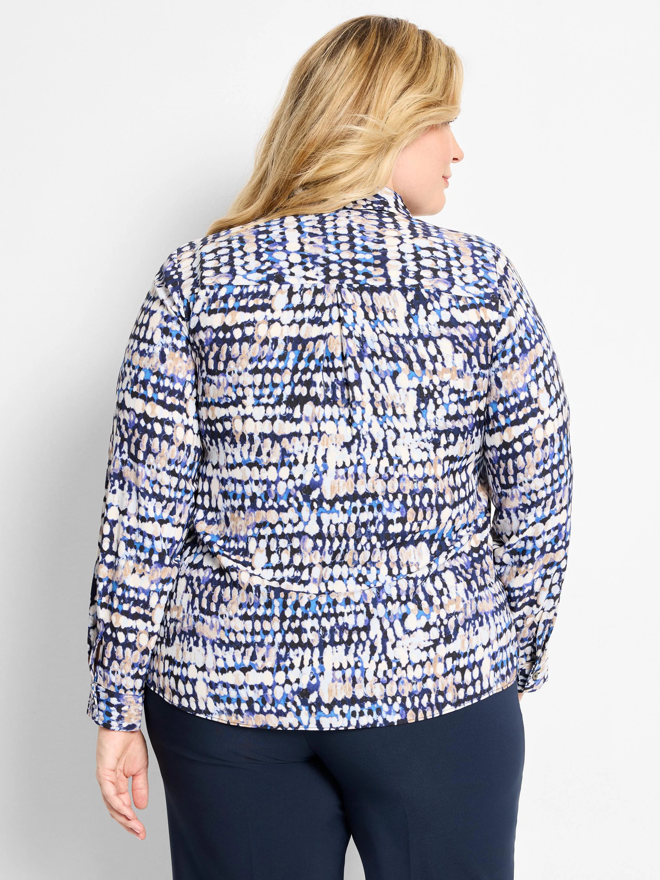Long-sleeve blouse with abstract dot pattern in dark blue, light blue, beige, white, and black. Features collar & back pleat.
