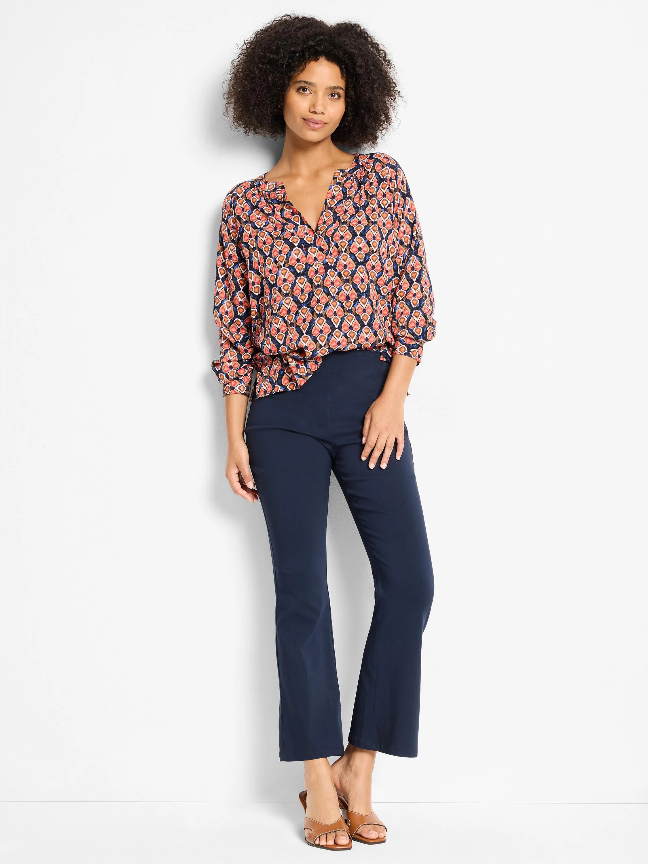 Harvest Ikat Top: Navy blouse with coral, orange, & blue geometric ikat pattern. Notch neck, 3/4 rolled sleeves.