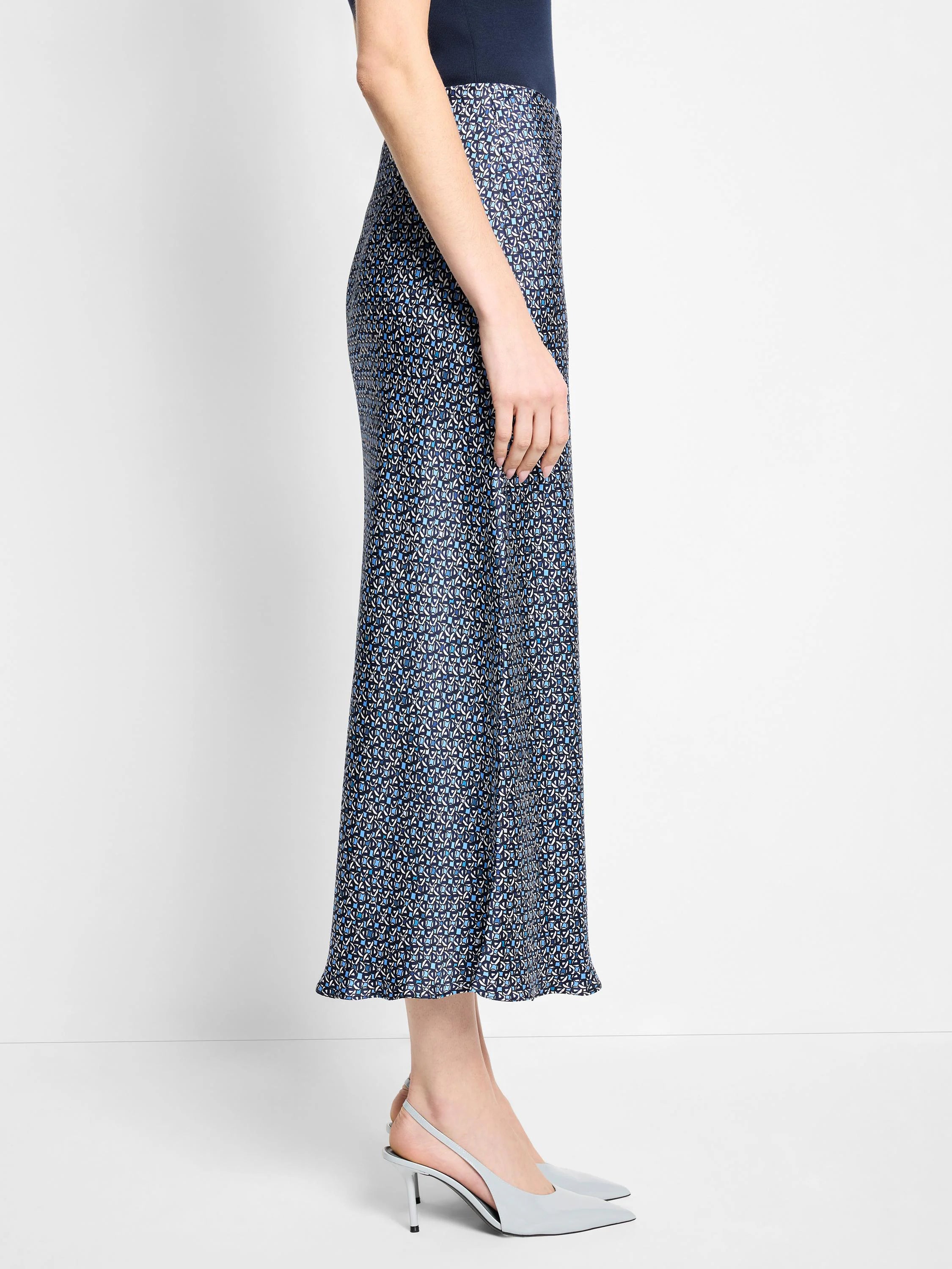 Midi slip skirt in navy blue with a light blue and white floral pattern.  A-line silhouette.