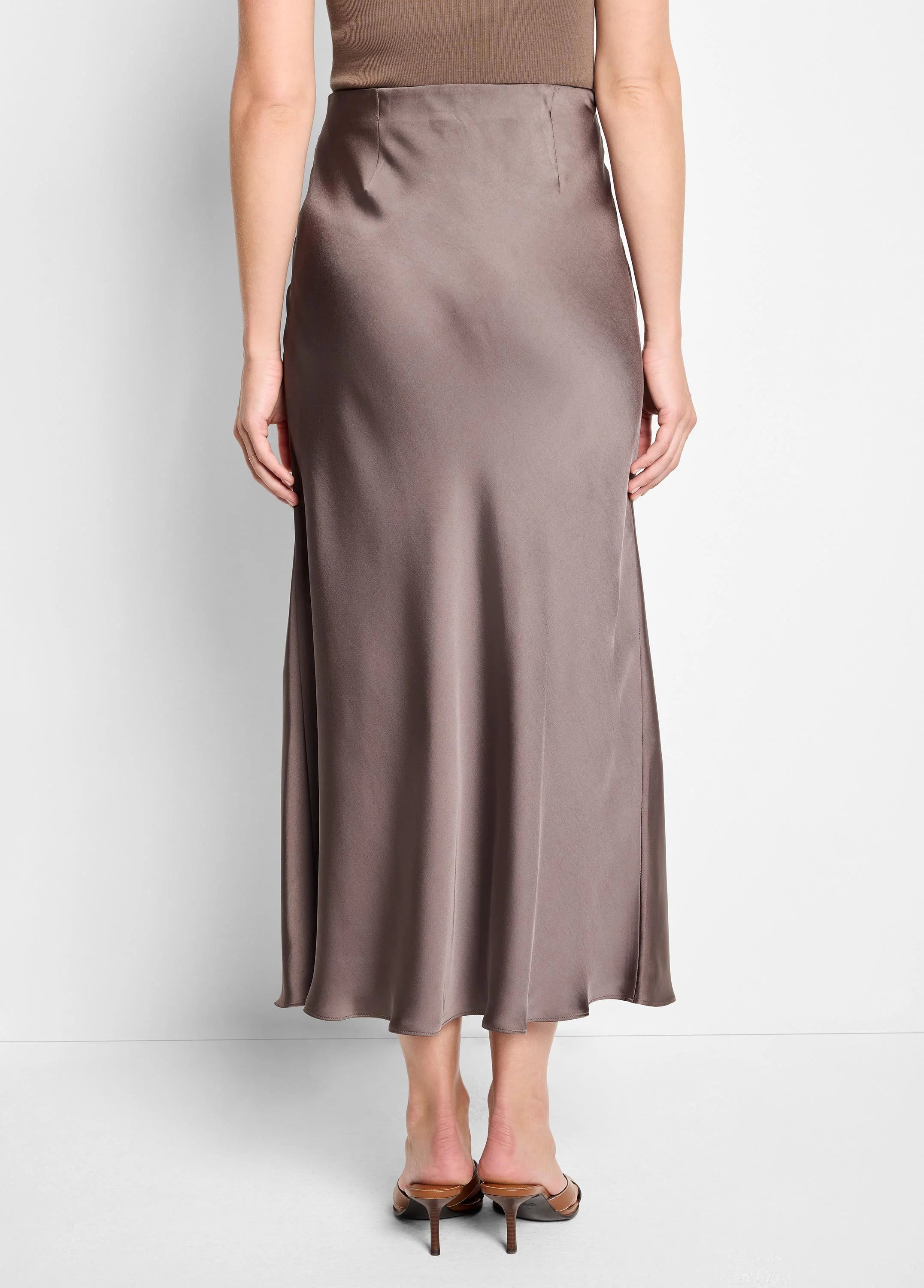 Glossy taupe slip skirt with a smooth, flowing drape; high-waisted and midi length.