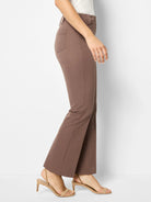 Medium brown demi boot pants on a model, featuring belt loops, a single visible back pocket, and a slight flare.