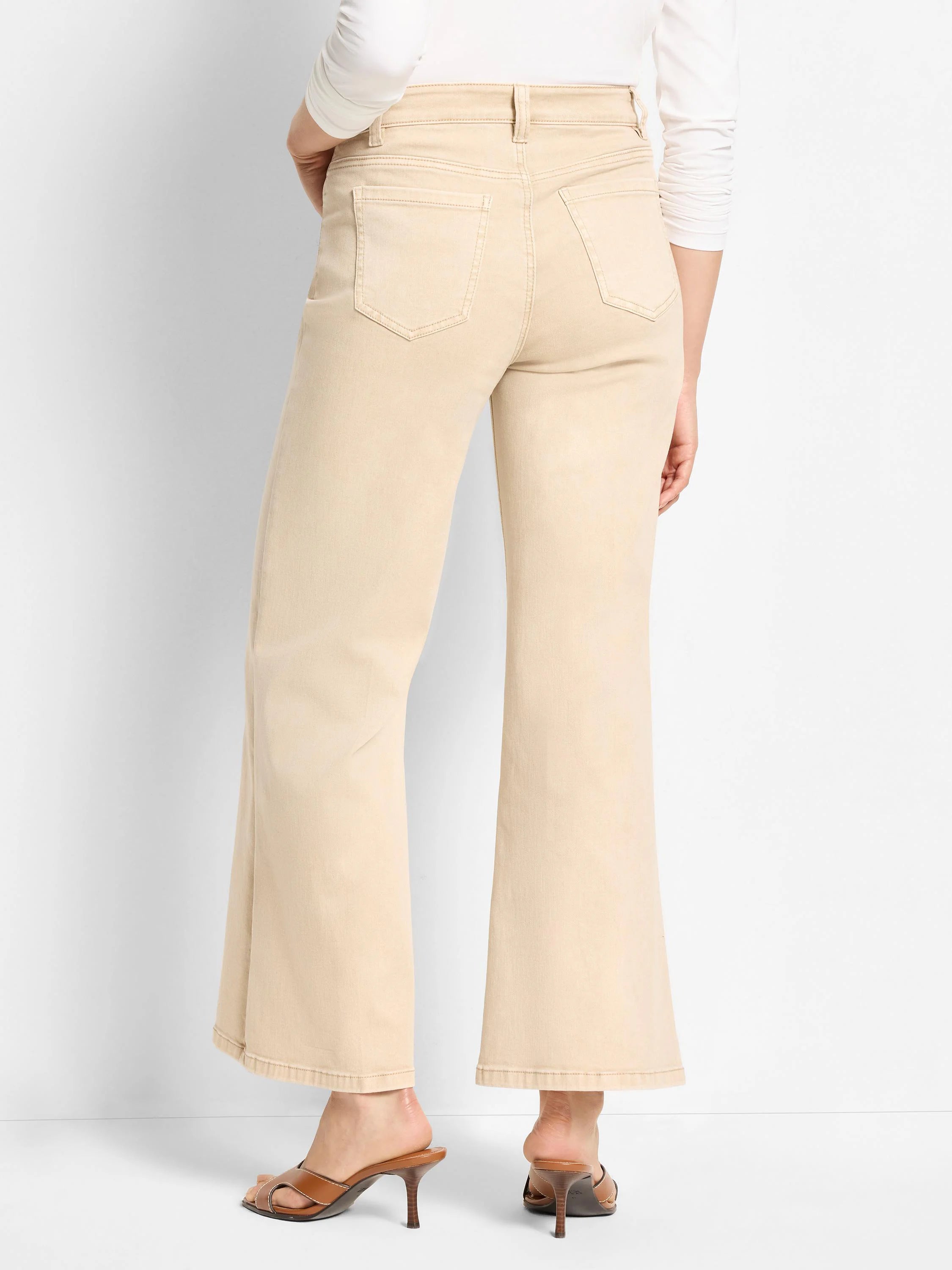 Back view of light tan boot flare jeans with visible back pockets and belt loops.
