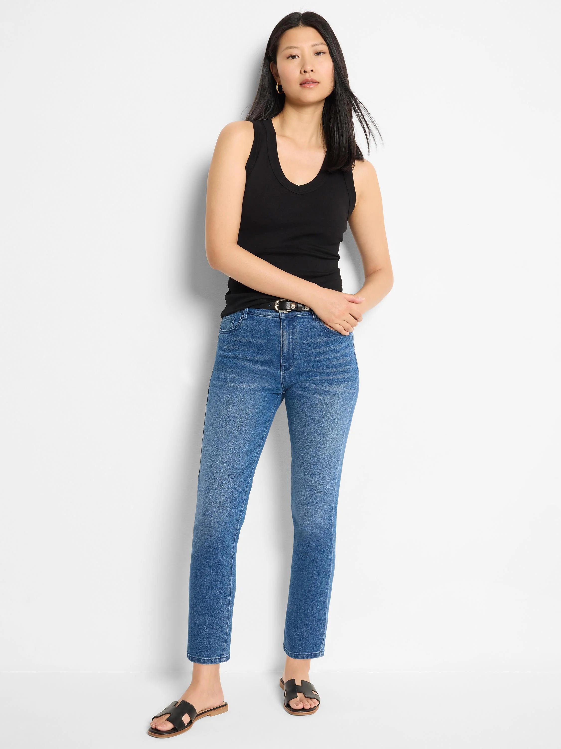 Medium blue denim jeans with a straight ankle cut and subtle fading.