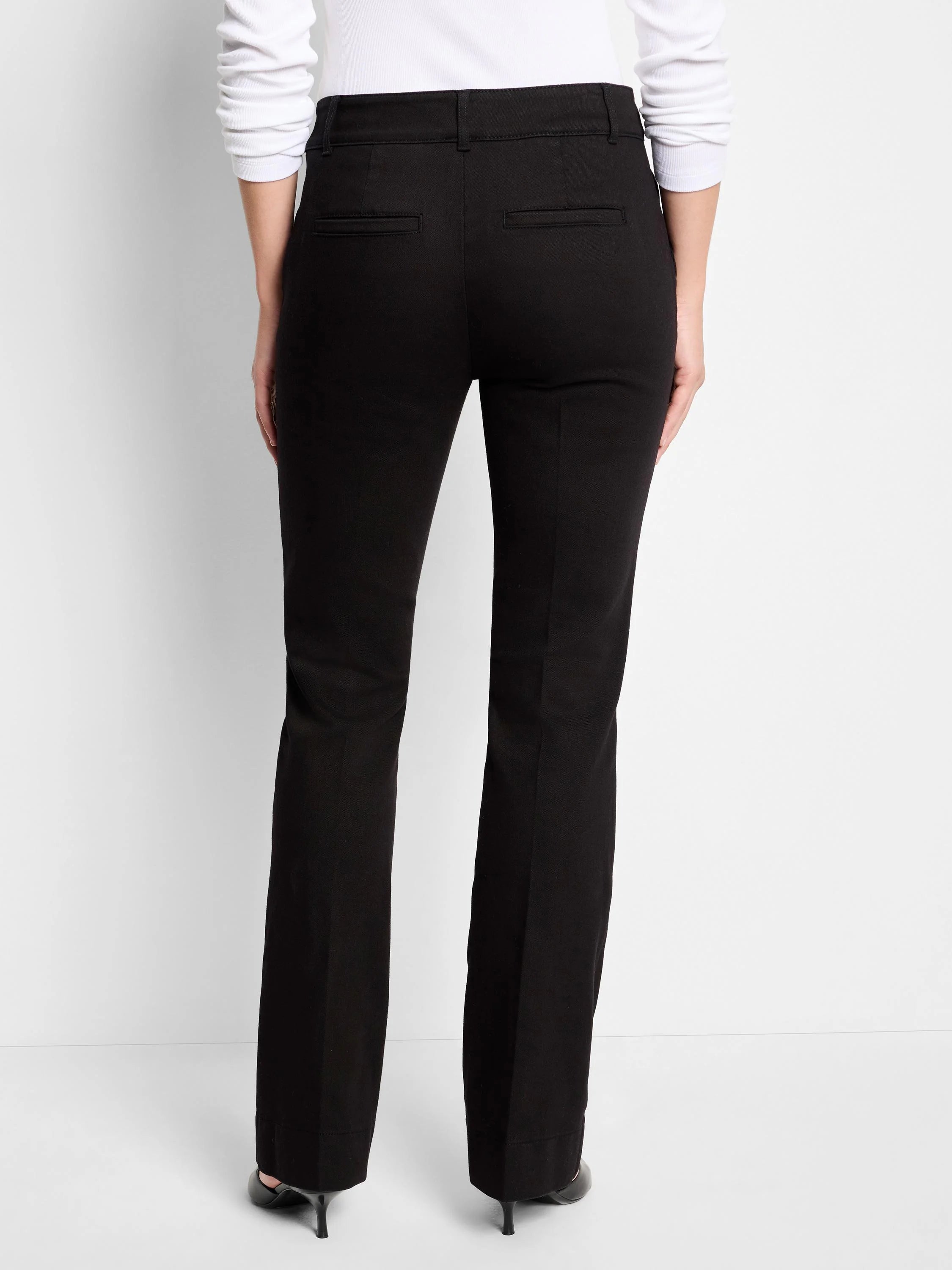 Black bootcut mid-rise trousers; back view. Slight flare at ankle.