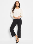 Black bootcut pants, fitted through the leg, gently flaring to a cropped ankle length.