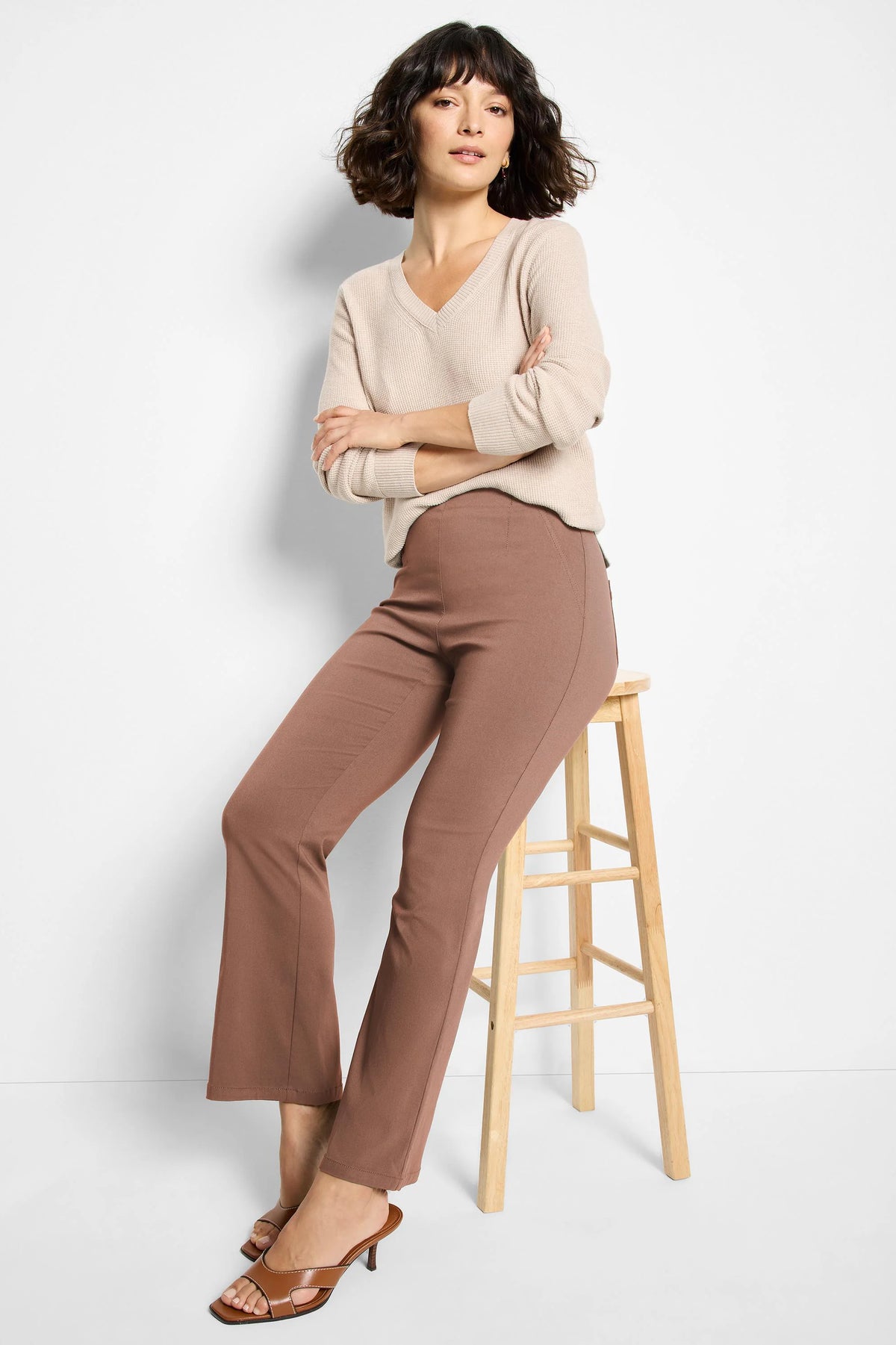 Mauve brown bootcut pants on a model, featuring a smooth finish and subtle vertical leg seams.