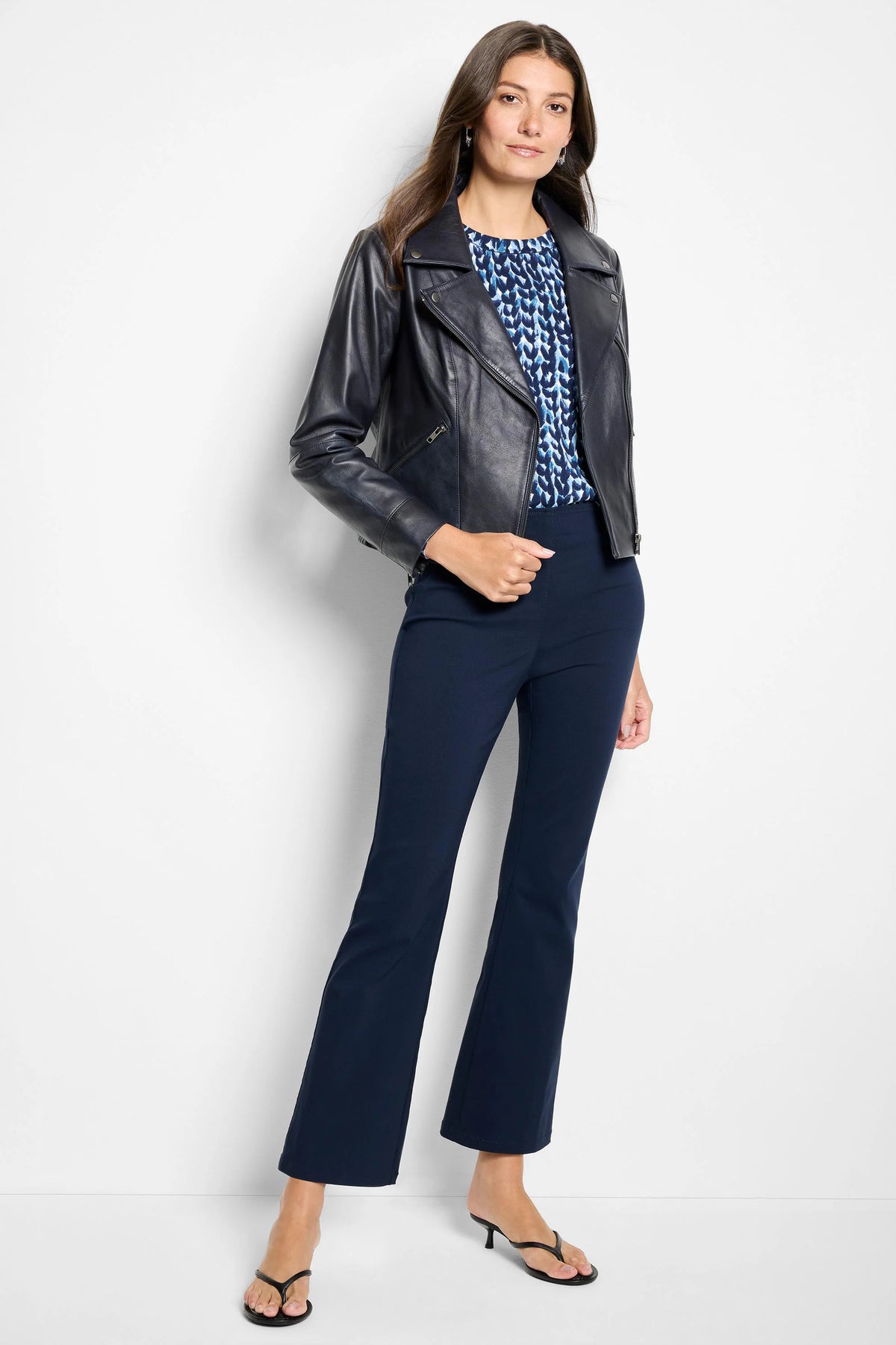 Dark navy blue ankle-length pants with a slight bootcut flare and smooth texture.