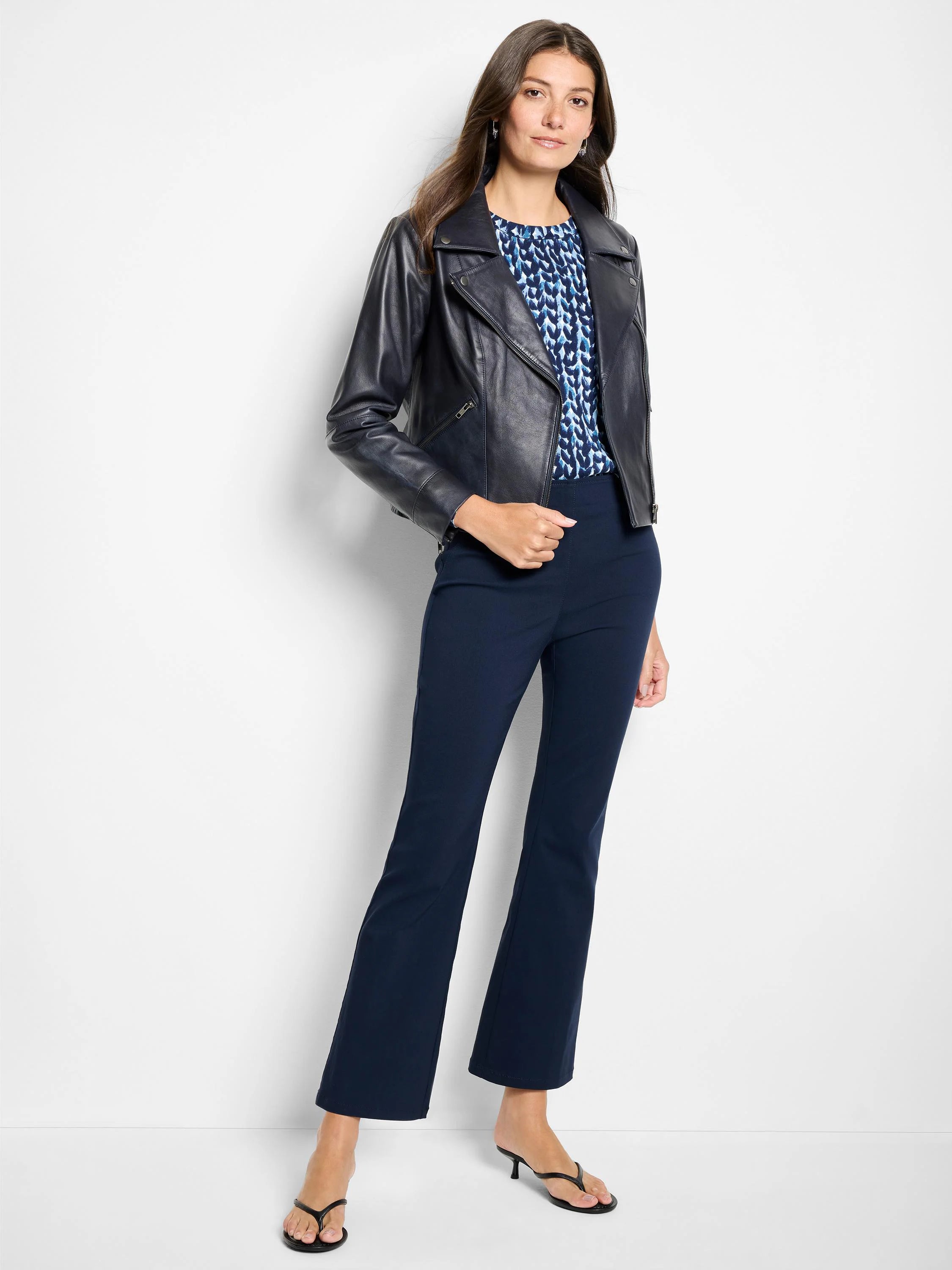 Dark navy blue ankle-length pants with a slight bootcut flare and smooth texture.
