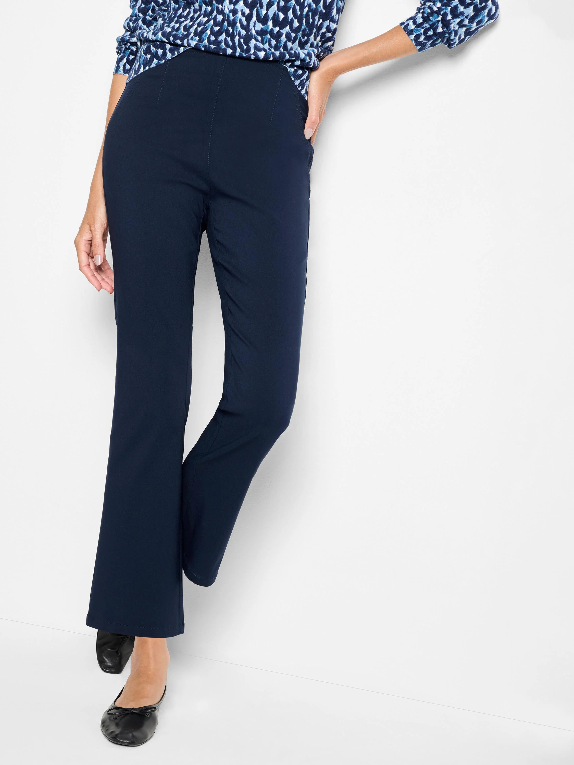 Navy blue bootcut pants on a model, showing a smooth front and subtle vertical seams.