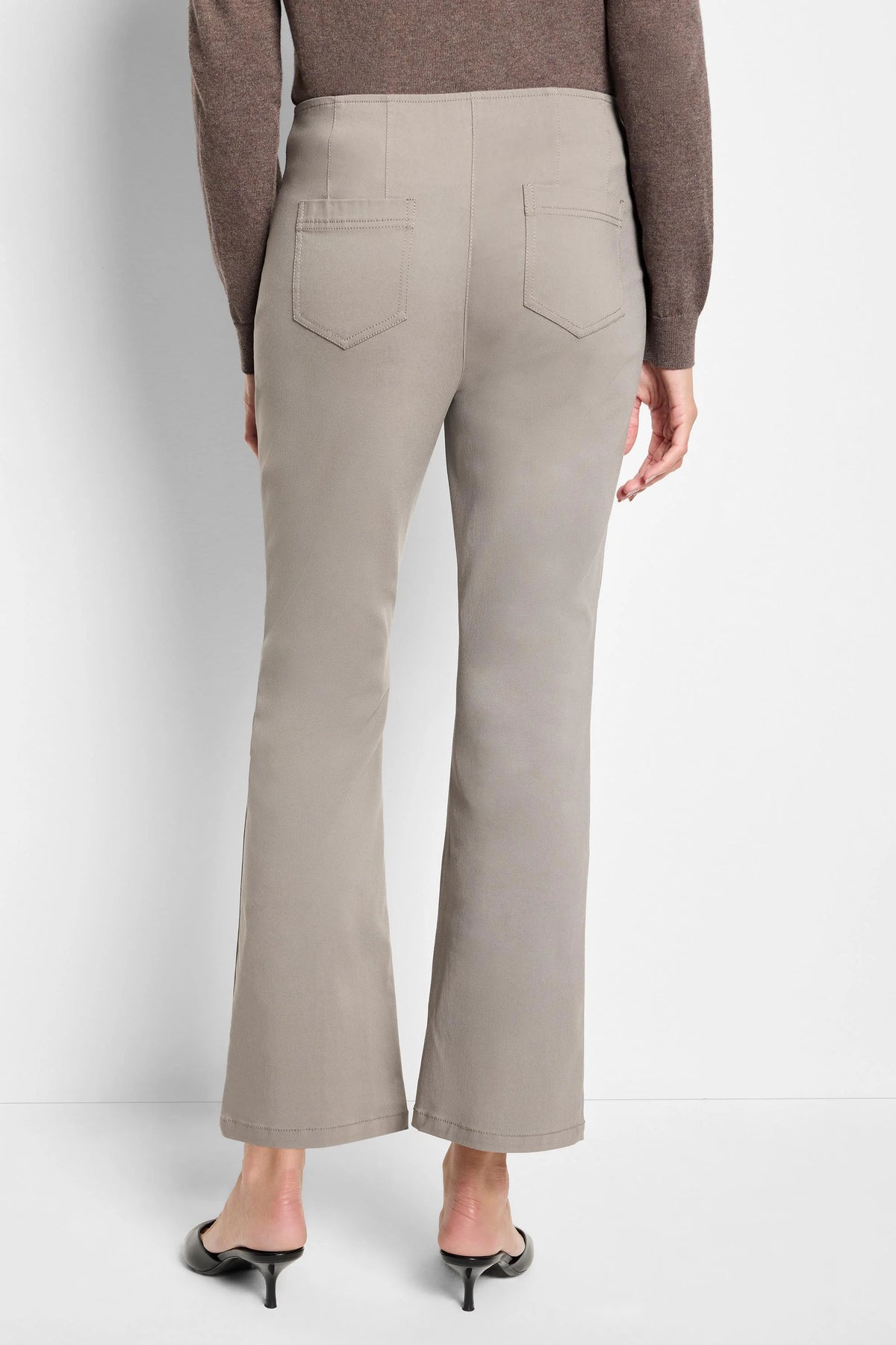 Light taupe bootcut pants shown from behind, featuring back patch pockets with visible stitching and a smooth waistband.