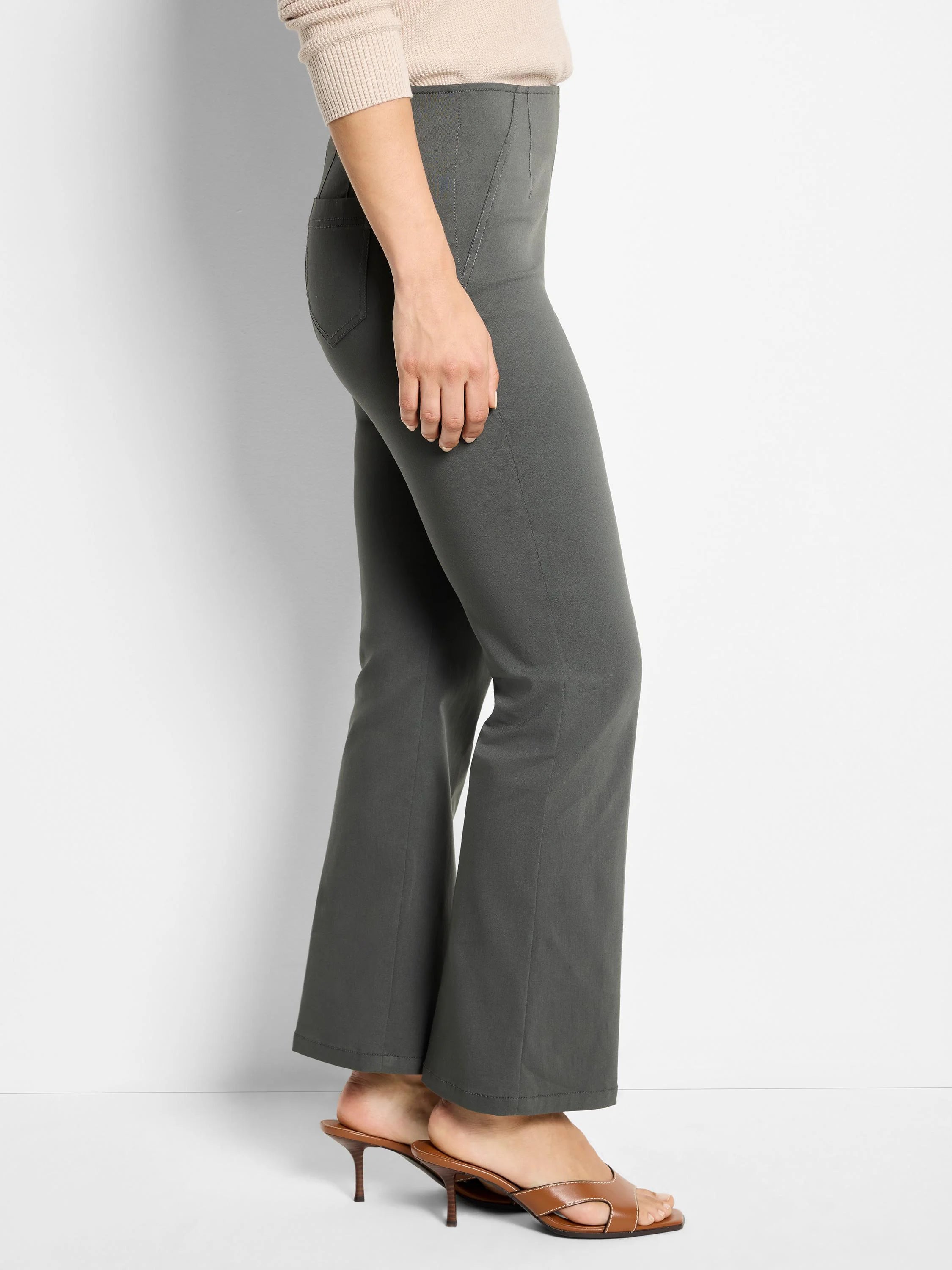 Dark grey boot-cut pants, fitted through the thigh with vertical front seams.