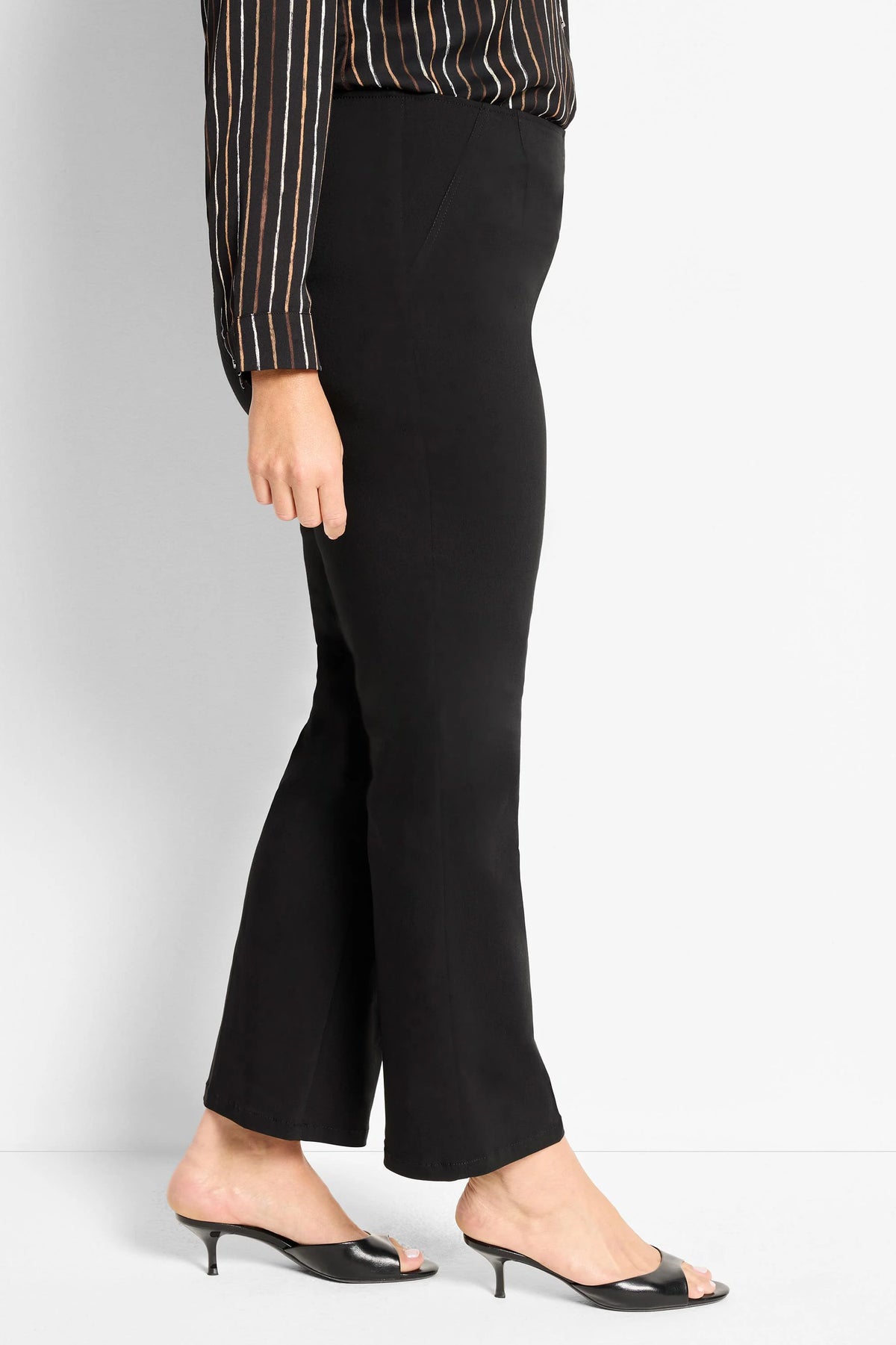 Black wonderstretch bootcut pants, shown worn on a model from waist to ankle.