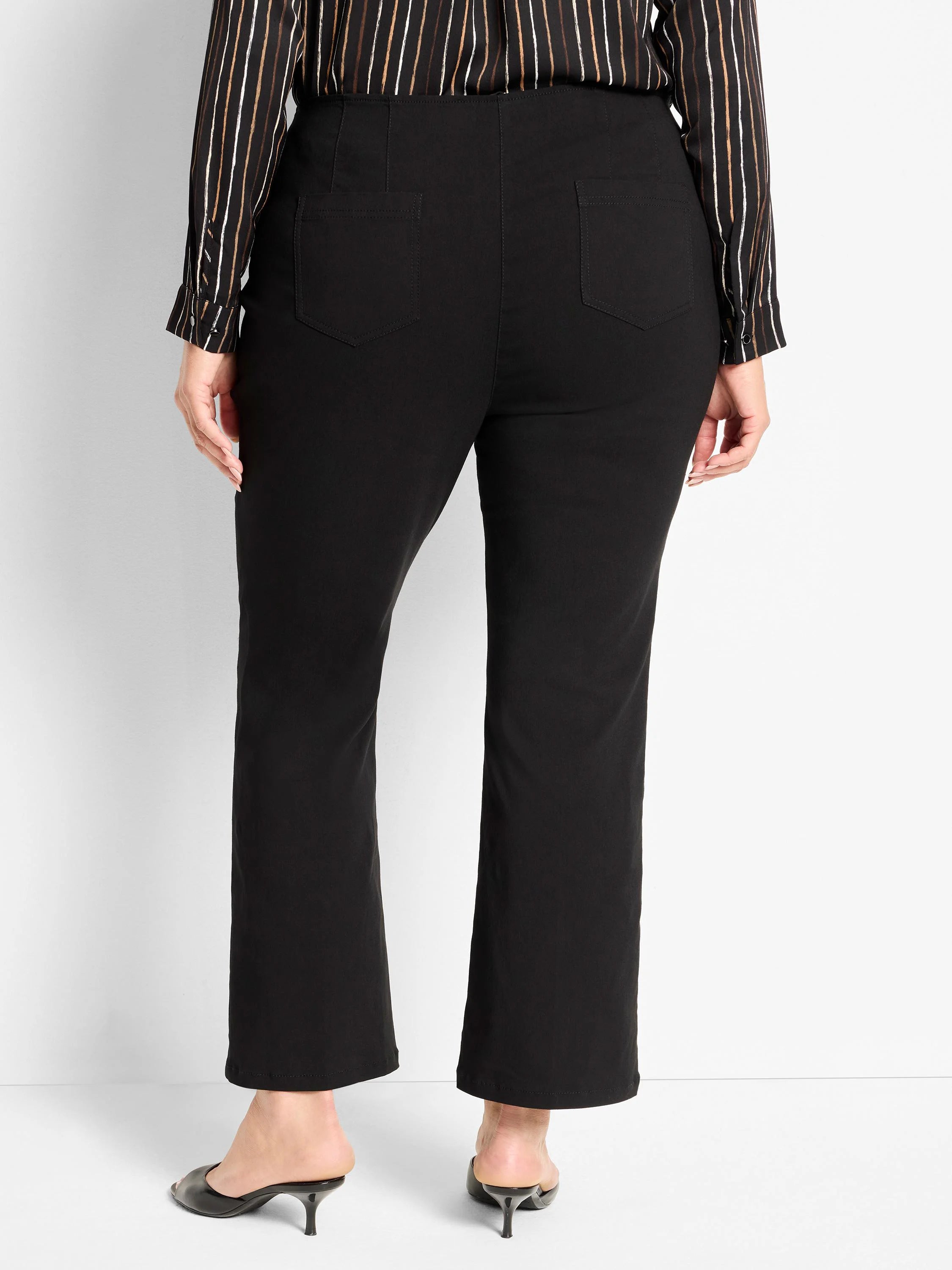 Black high-waisted bootcut pants with back pockets, shown from behind.
